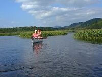 Flat-water canoeing with mountains in the background.
